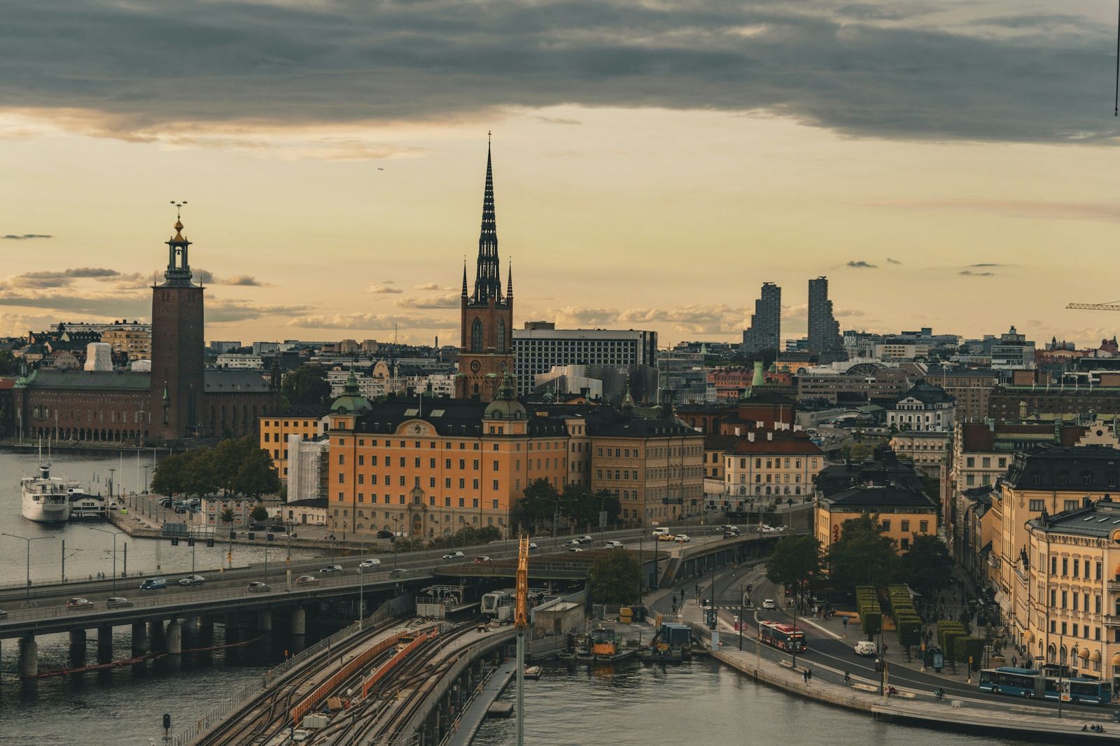 Stockholm at golden hour, looking over the bridges and water towards Riddarholmen church and the City Hall tower