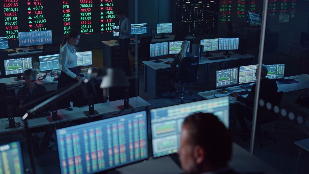 Trading floor with rows of screens showing market data